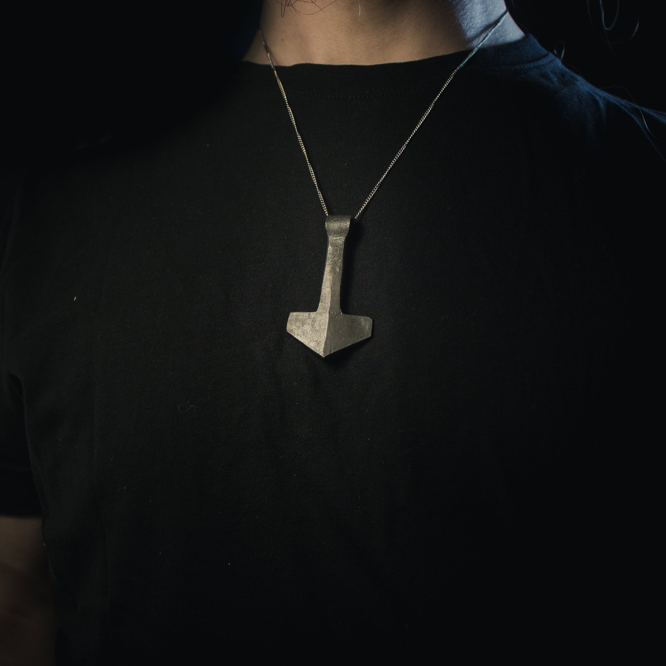 model wearing forged thors hammer necklace