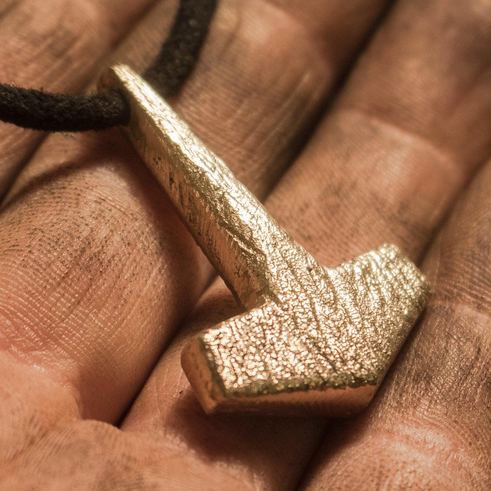close up on bronze mjolnir pendant