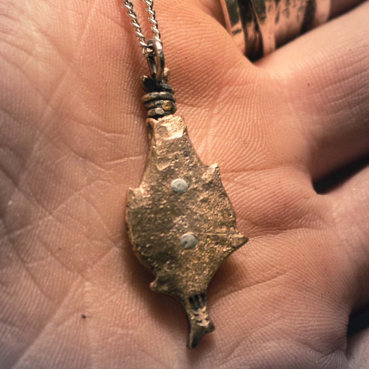 Viking-inspired protective pendant in bronze, featuring traditional bindrunes within an artistic teardrop border