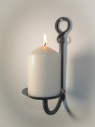 Decorative iron candle holder with a rustic finish and elegant craftsmanship.