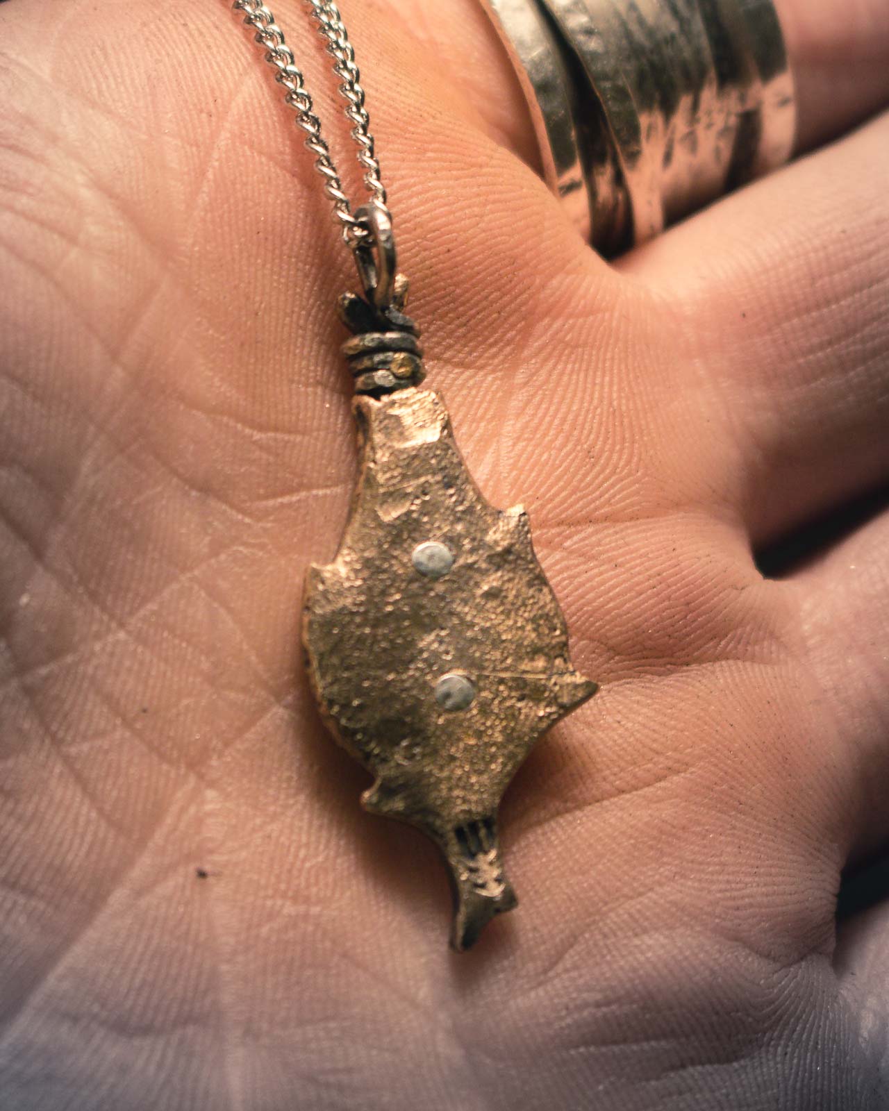 Viking-inspired protective pendant in bronze, featuring traditional bindrunes within an artistic teardrop border